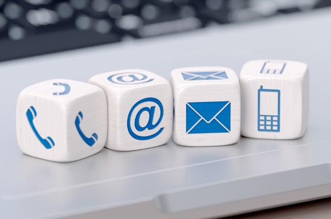 Four dice with communication icons on the sides